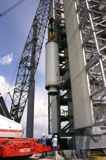 Workers erect the first stage of a Lockheed Martin Launch Vehicle-2 (LMLV-2) at Launch Complex 46 at Cape Canaveral Air Station ca. 1997