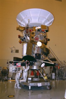 Jet Propulsion Laboratory (JPL) worker Mary Reaves mates connectors on a radioisotope thermoelectric generator (RTG) to power up the Cassini spacecraft, while quality assurance engineer Peter Sorci lo...