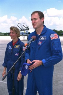 STS-94 Pilot Susan Leigh Still watches as Commander James D. Halsell, Jr., speaks to the media after the crew arrived at the Shuttle Landing Facility at Kennedy Space Center  ca. 1997