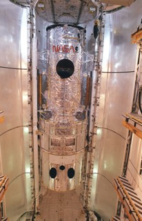 1990 - This photograph shows the Hubble Space Telescope (HST) installed in the cargo bay of the Space Shuttle Orbiter Discovery for the STS-31 Mission