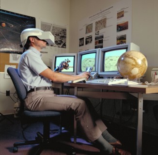 1992 - Virtual Environment Telepresence workstation, simulated Mars Exploration shows Lewis Hitchner with virtual helmet and EXOS Dexterous interface (virtual hand)