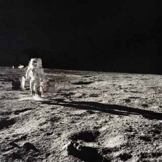 Astronaut Alan Bean with subpackages of the ALSEP during EVA