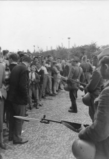 Heavily armed troops of the East German police patrol