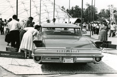 Interested spectators look inside an Oldsmobile, 1959
