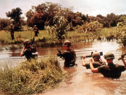 16th Armored Division members cross a jungle river in previous Viet Cong territory. Vietnam, 9/65.
