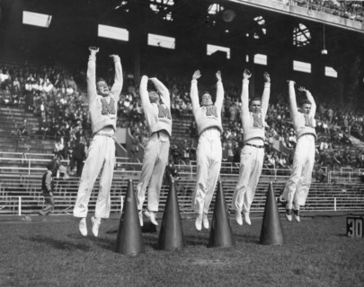 Cheerleaders lead the students in cheering for the team at the Maryland-Penn State game. College Park, MD,  9/25/50.