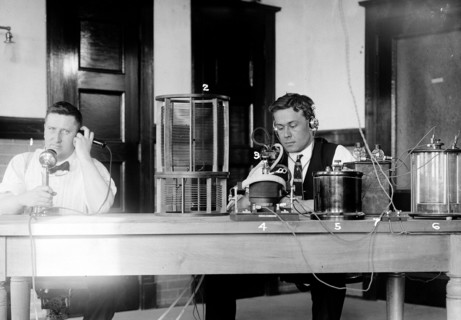Two men sitting in what the original caption calls a laboratory