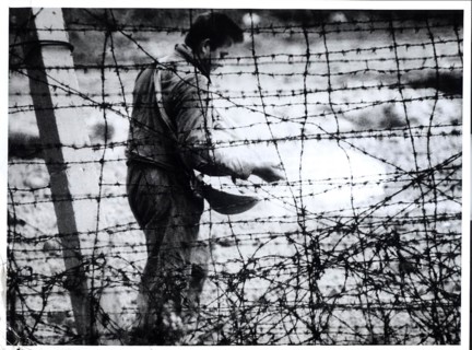 'Death Strip' Although He Resembles A Farmer Sowing Seed, This East German Workman Is Sprinkling