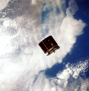View of the Syncom IV satellite in orbit over the earth