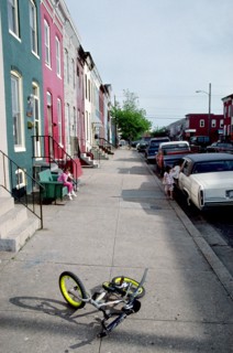June 11, 1998 - small bike lying on sidewalk in urban neighborhood