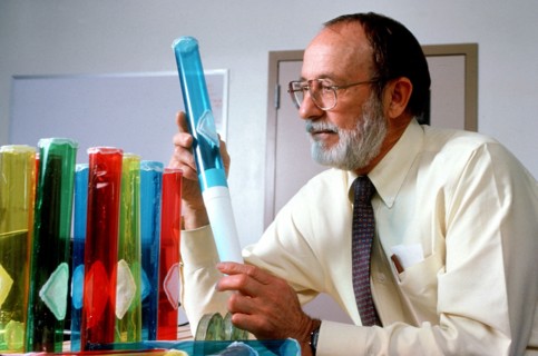 Scientist examining beakers ca. 1996