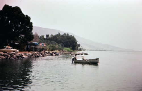 Two men rowing a boat in Lake Gailee in Israel
