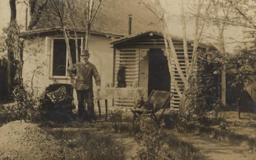 Man In A Hat In The Garden In Front Of His House