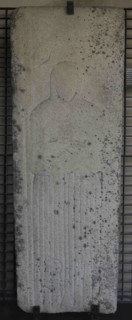 Tombstone with bas-relief depicting a woman wearing the Franciscan habit