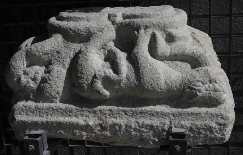 Double capital depicting the struggle between humans and animals