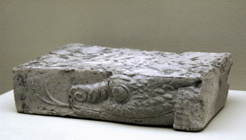 Fragment of baked clay brick, moulded and unglazed