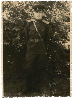 Soviet Army lieutenant against a background of bushes.