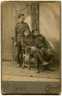 Three soldiers in field uniform.