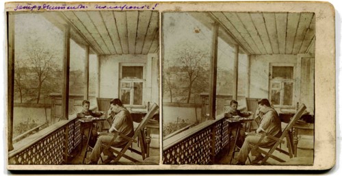 A stereo, a man with a boy playing checkers on the porch at home.