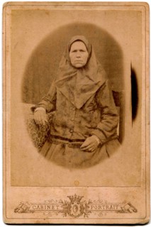 An elderly woman in a headscarf.