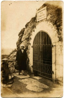 A woman stands near the entrance to the Grotto of Lermontov.