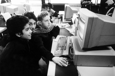 Kids use computers at school.