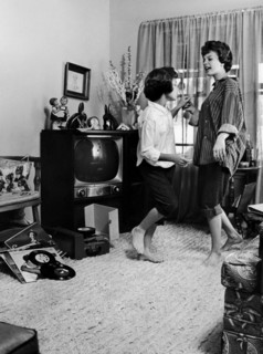 Young women dancing at home.