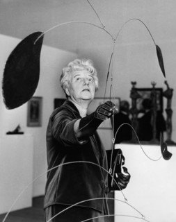Peggy Guggenheim portrait in front of an Alexander Calder sculpture.