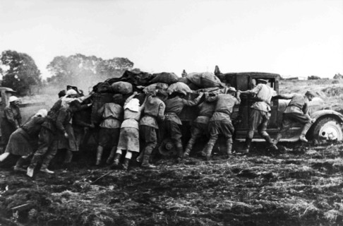 Farmers Help Soldiers Pushing A Truck Loaded In The Russian Steppe.