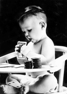 Child In High Chair With Playing Cards.