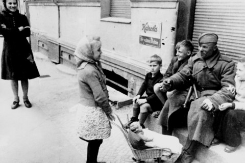 II world war, berlin, russian soldier plays with a young girl