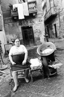 Woman selling chestnuts in an alley in Naples, Italy, 1977