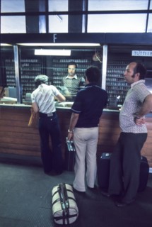 Central station of milan, passengers at ticket office , 70's