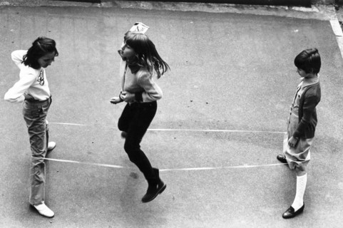 Children playing  elastic playground game, 70's