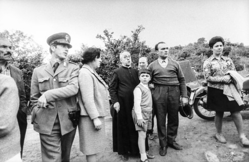 Police force, priest and a group of people, 70's