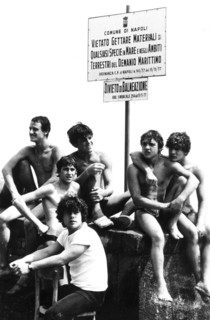 Young man at naples's harbour, no swimming sign, 70's