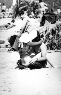 Couple in love kissing on the beach, 70's