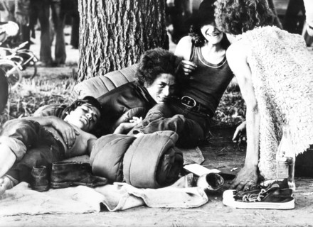 Four persons with sleeping bag and a bottle of coke, 70's