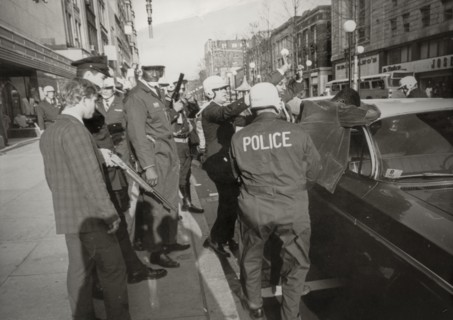 Suspect two black people looters are serched by police in downton washington, 1968