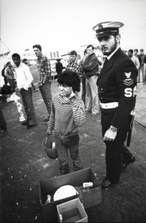 Little boy street vendor near an american soldier of saratoga aircraft carrier, 80's