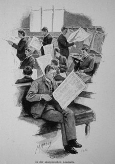 Man Reading Newspaper In An Academic Reading Room