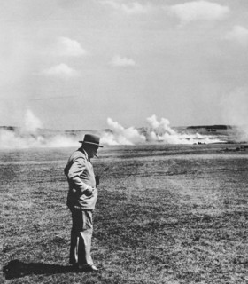 Mr Churchill, cigar in mouth watching realistic mock battle in the Southern Command using live ammunition.