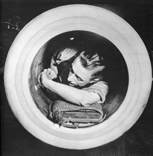 Preparing the worn inner tube of a massive naval gun whilst at sea.