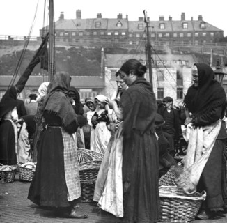 Fish women at Fish Quay with baskets of herring.