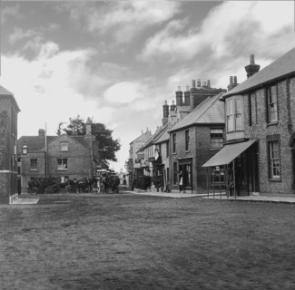 Coaching inn with horses and coaches outside.