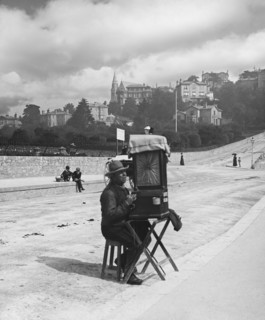 Blind beggar man playing a barrel organ in Bute Torquay.