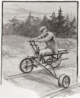 Three wheeled velocipede on a railroad track.