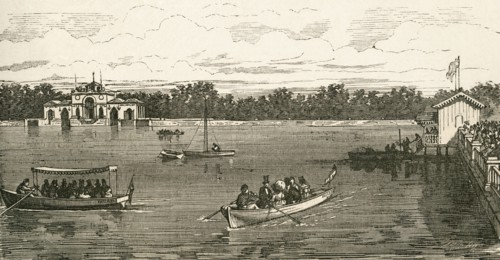 People boating on the lake in the Retiro Park.