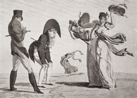 Two ladies lose their hats on a windy day.
