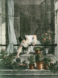 Young woman watering plants on her balcony.